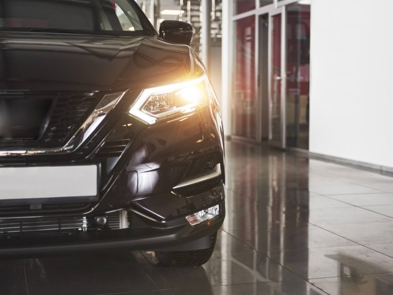 the-headlights-and-the-hood-of-a-black-luxury-car.jpg
